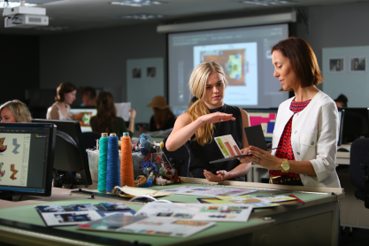 A student speaking with an instructor indoors.