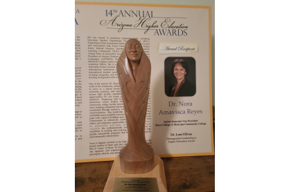 Wooden carving/award, along with program from presentation.