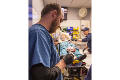 Nursing students working with a mock patient. 