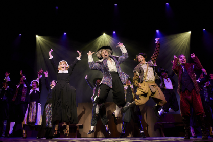 Women and men in costumes jumping up