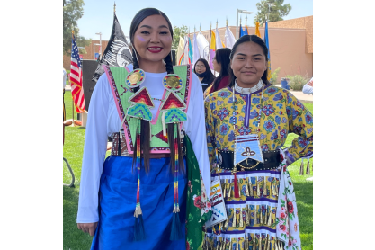 Photo of two Native American women in traditional, colorful dress