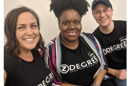 Three smiling people, the MCC eLearning team, all wearing black t-shirts with a graphic with the text Z Degree.