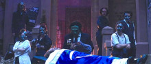 Photo of Antigone scene with multiple actors.