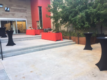 Courtyard of the PAC set with high-top tables and buffet of food. 