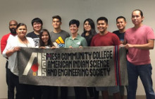 Students and Advisors posing with the new official AISES banner