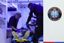 MCC paramedicine students working with a mock patient on a stretcher in the back of an ambulance simulator.