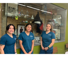 Three MCC nursing students wearing scrubs.