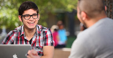 Students outside with a laptop