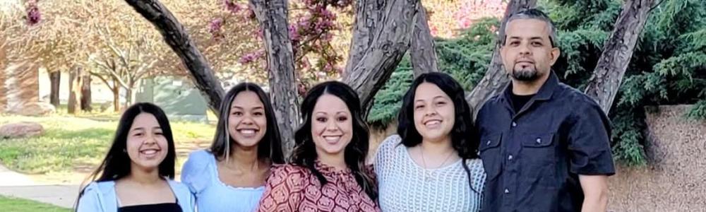 Priscilla Gutierrez, pictured with her family, received the 2023 NAU Public Service Award. From left: daughters, Destani, LaToya and Cienna, and husband, Hugo