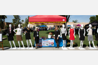 Alumni board members pose with mannequins at Dress for Success booth