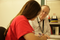 Professor seated next to a student