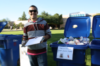 Student posing next to new recycle bins