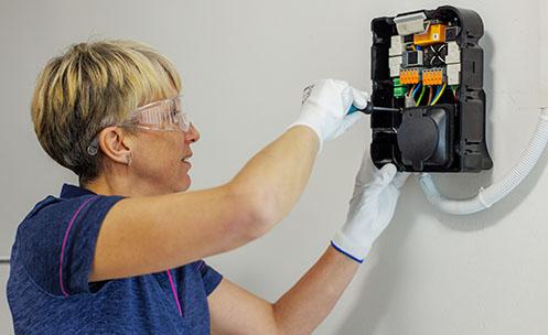An electrician installing a charger.