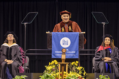 Chancellor Steven Gonzales speaking at the graduation podium.