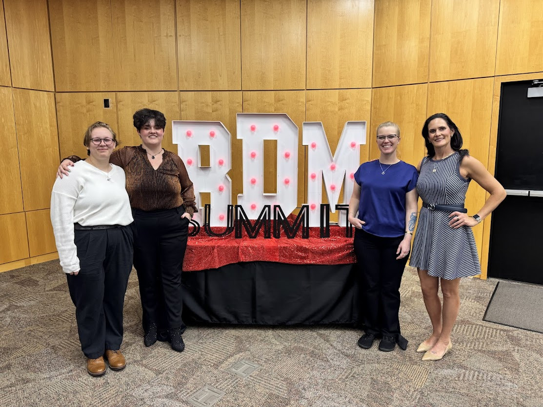 Student Life employees by the Summit Award display