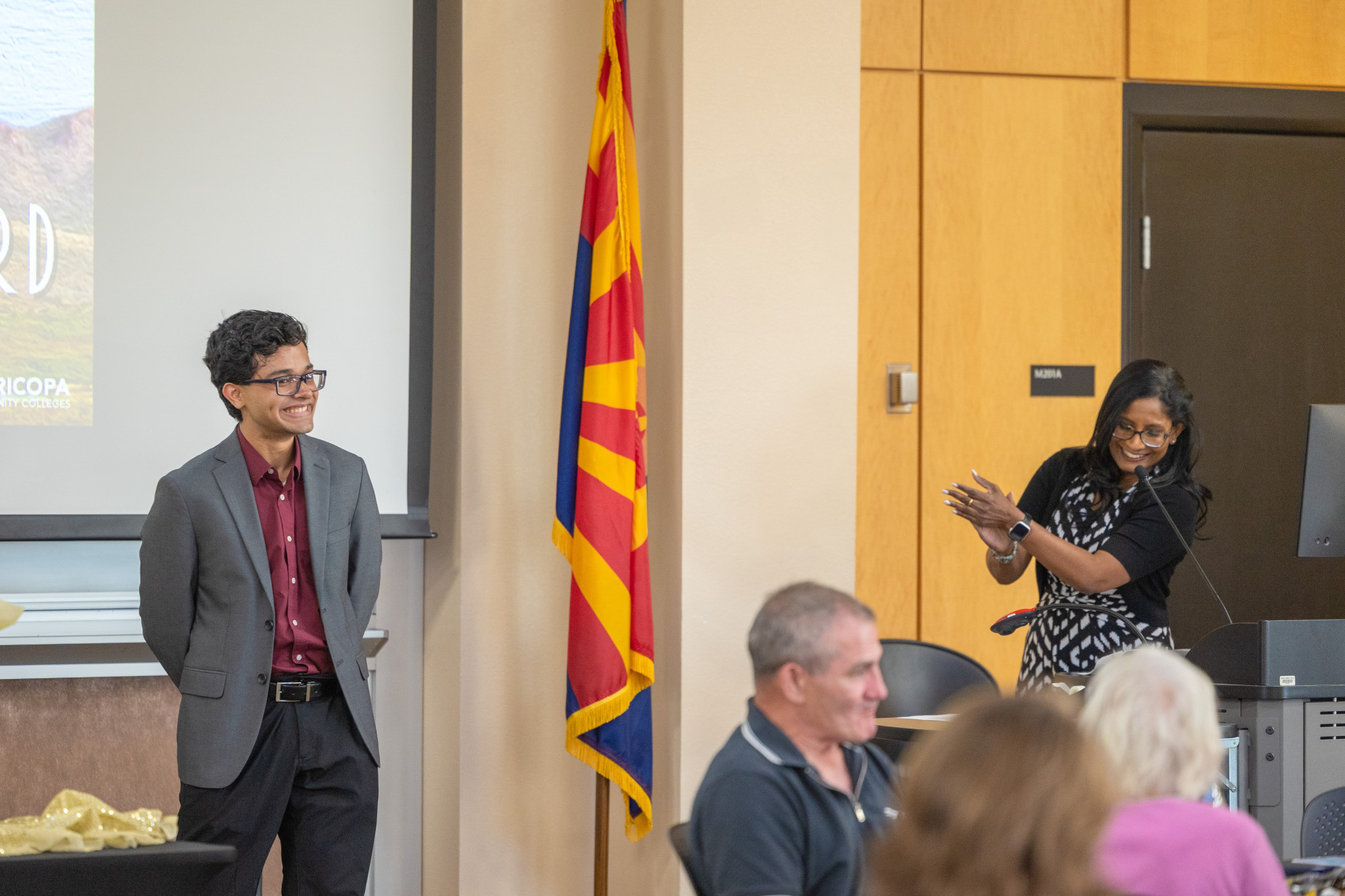 A student being honored by his professor for a Summit Award