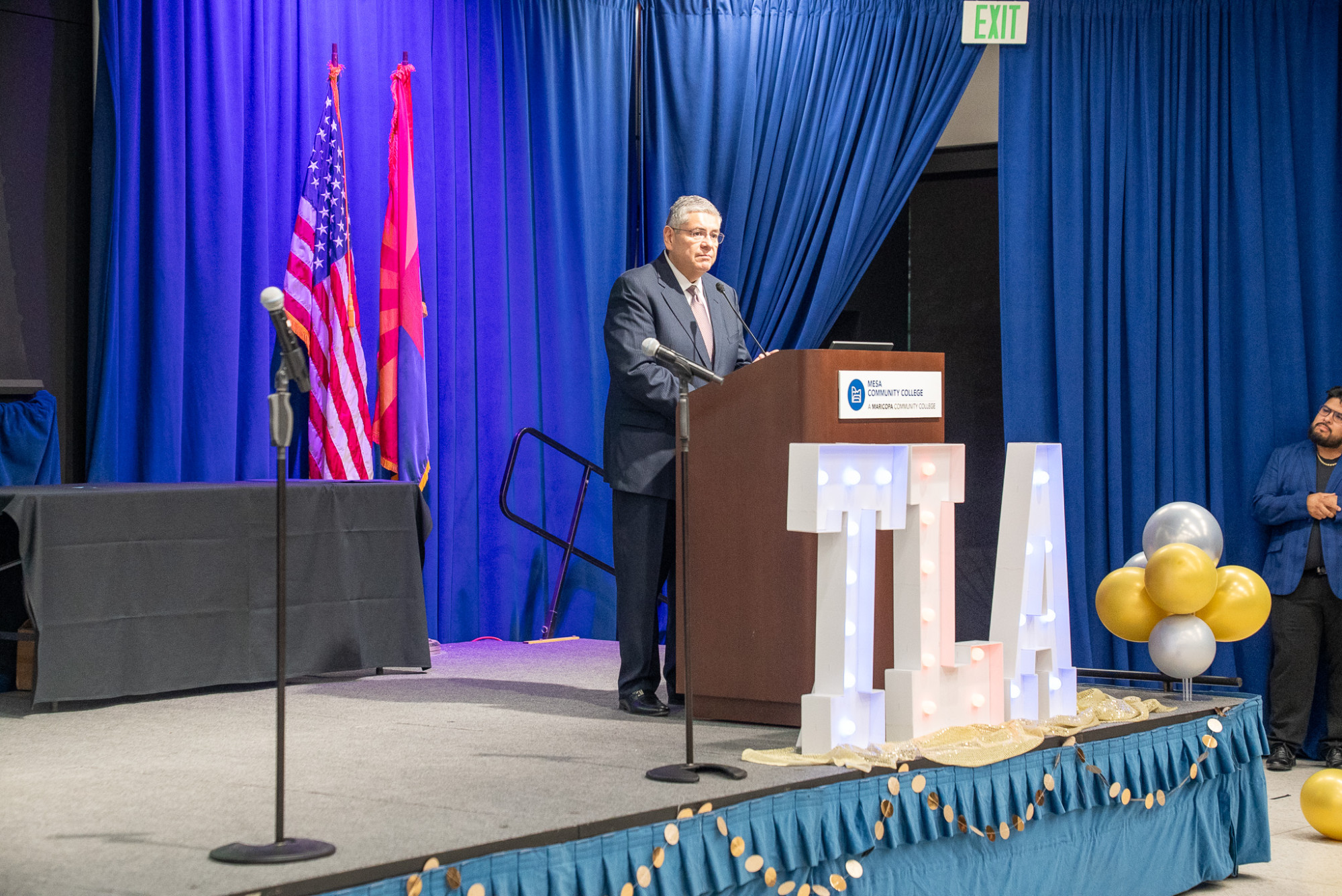 Dr. Daniel speaks with the audience from the podium on stage