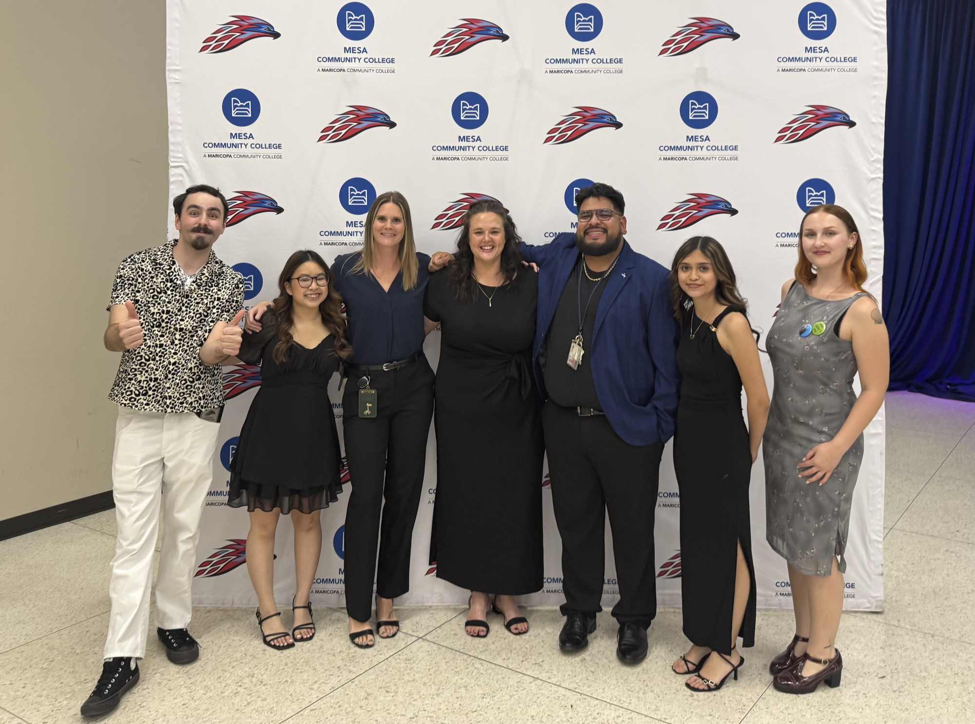 Student Life team poses by Tbird backdrop