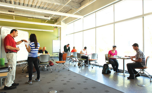 A student and instructor talk at the whiteboard.