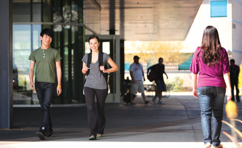 Students walk and talk on campus.