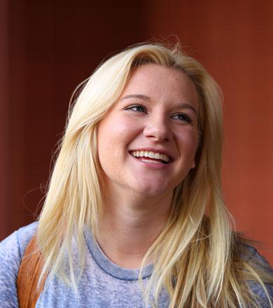 A student smiling looking away from the camera.