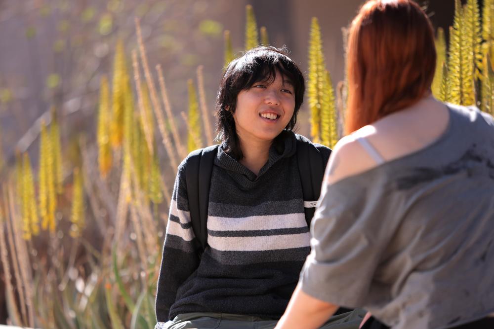 Male student speaking with a female student