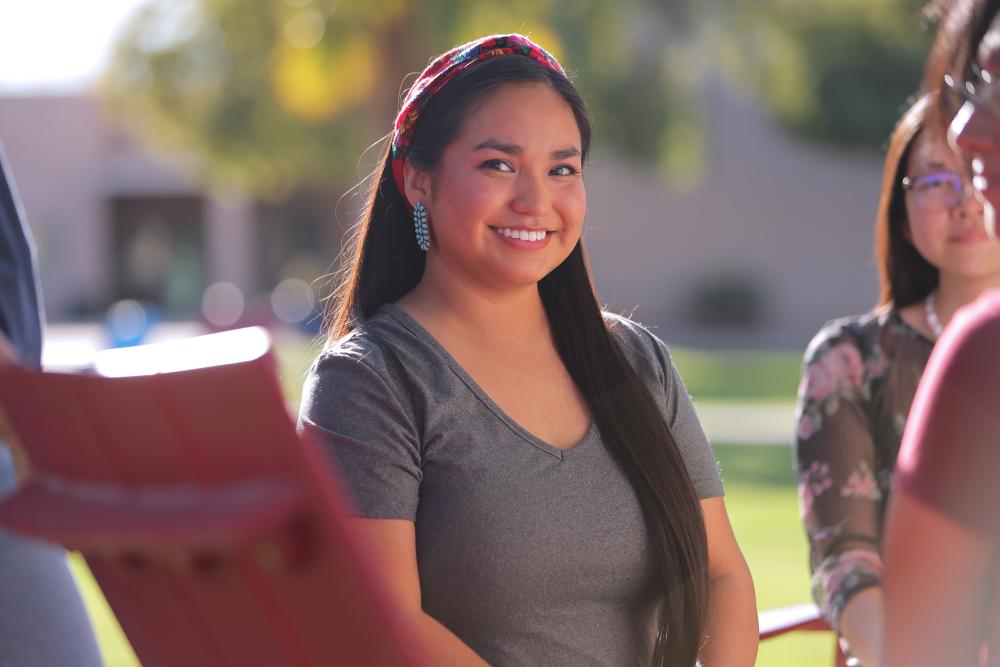 Female students sitting outside