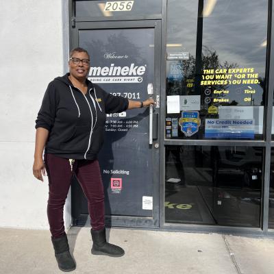 photo of LaVon in front of her Meineke store