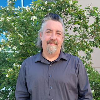 Headshot of Eric Mackey.