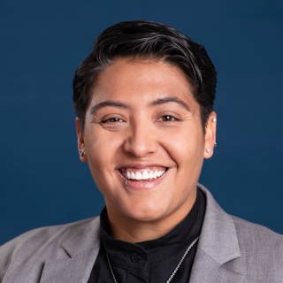 Lorena Austin wearing a black shirt and gray blazer