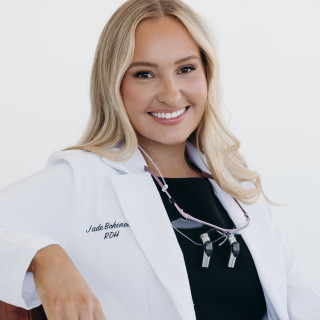 Jade Boheneck in a white dental hygiene coat. 